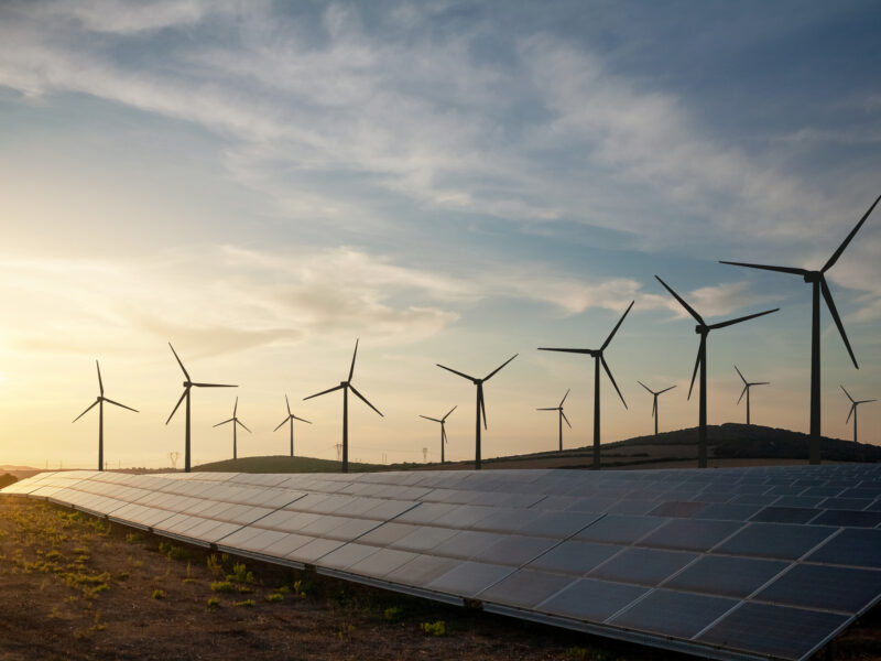 Solar panels and wind turbines generating renewable energy for green and sustainable future.