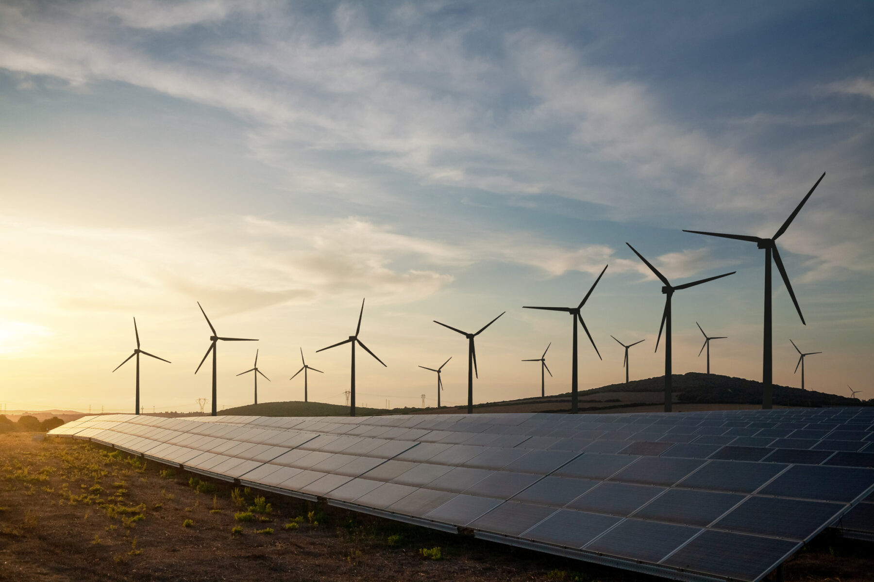 Solar panels and wind turbines generating renewable energy for green and sustainable future.