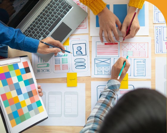 Website design planning meeting with diagrams and drawings